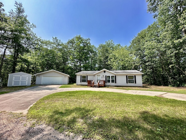 ranch-style house with an outbuilding, a shed, a front yard, and a garage