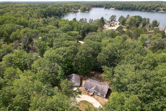 drone / aerial view featuring a forest view and a water view