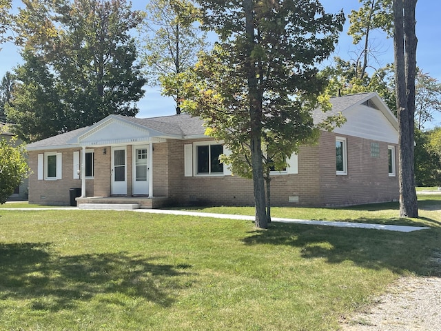 single story home featuring crawl space, a front lawn, brick siding, and roof with shingles