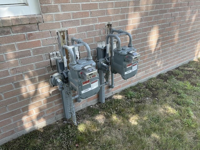 details featuring brick siding and gas meter