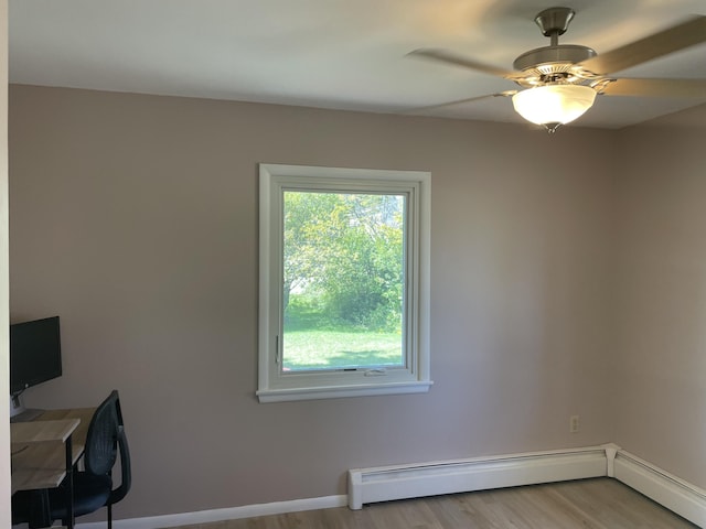 unfurnished room featuring wood finished floors, baseboards, baseboard heating, and ceiling fan