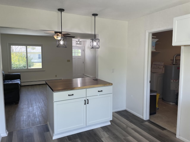 kitchen with washer and dryer, water heater, white cabinetry, baseboard heating, and dark wood-style flooring