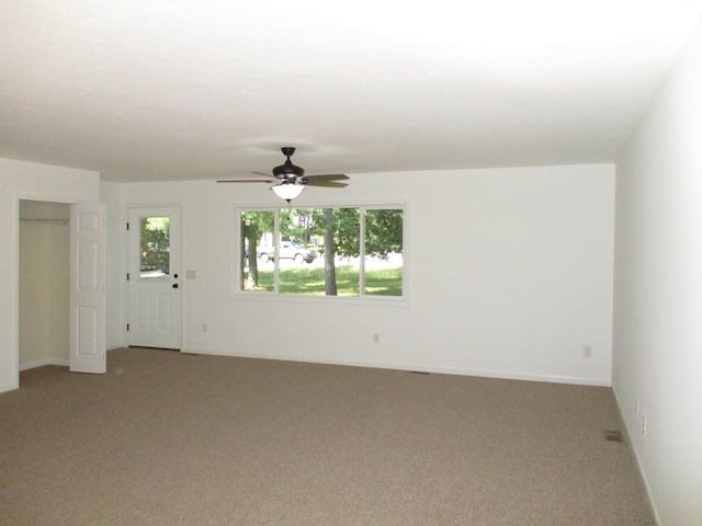 unfurnished room with light carpet and a ceiling fan