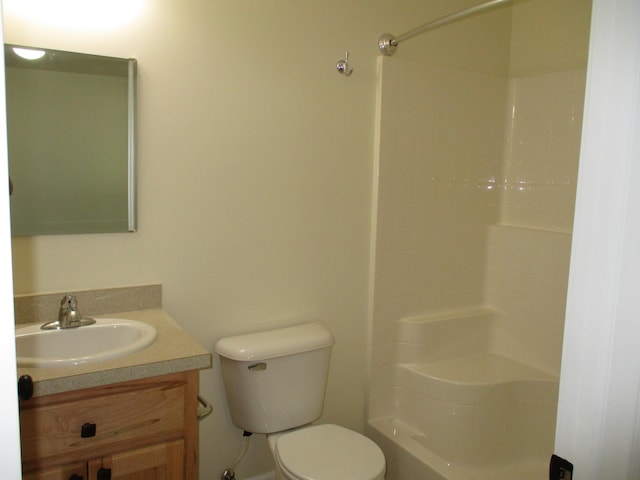 bathroom featuring vanity, toilet, and a shower