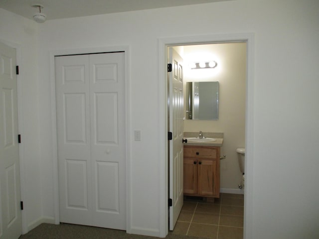 bathroom featuring vanity, tile patterned floors, and baseboards