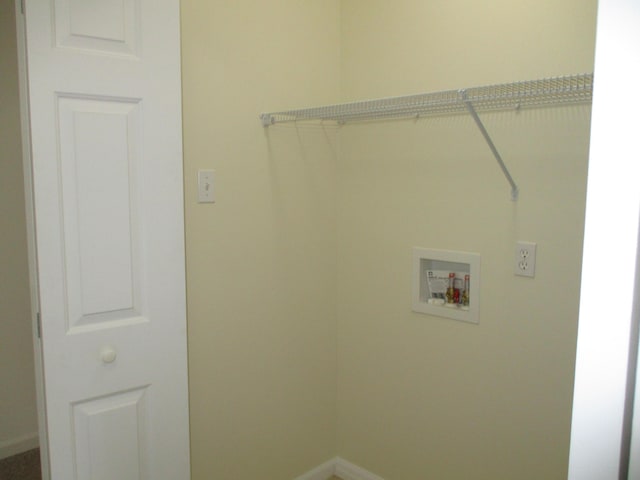 laundry room featuring baseboards, hookup for a washing machine, and laundry area