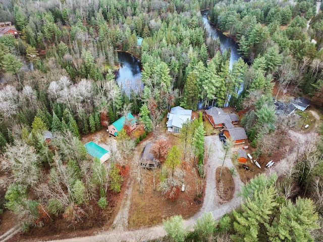 aerial view featuring a forest view and a water view