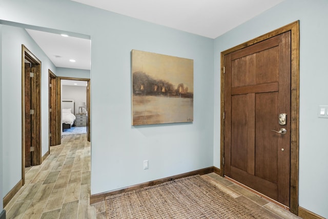 entryway featuring baseboards and wood tiled floor