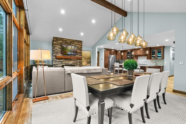 dining space featuring baseboards, beam ceiling, recessed lighting, light wood-style floors, and high vaulted ceiling