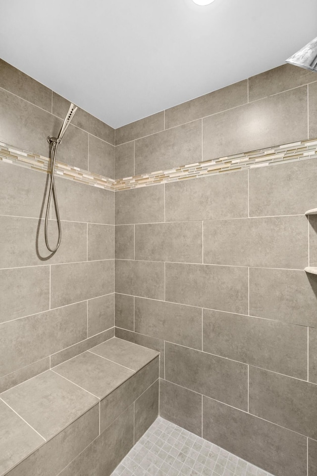 bathroom with a tile shower