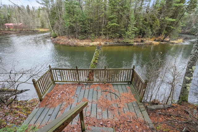 view of dock with a view of trees and a water view