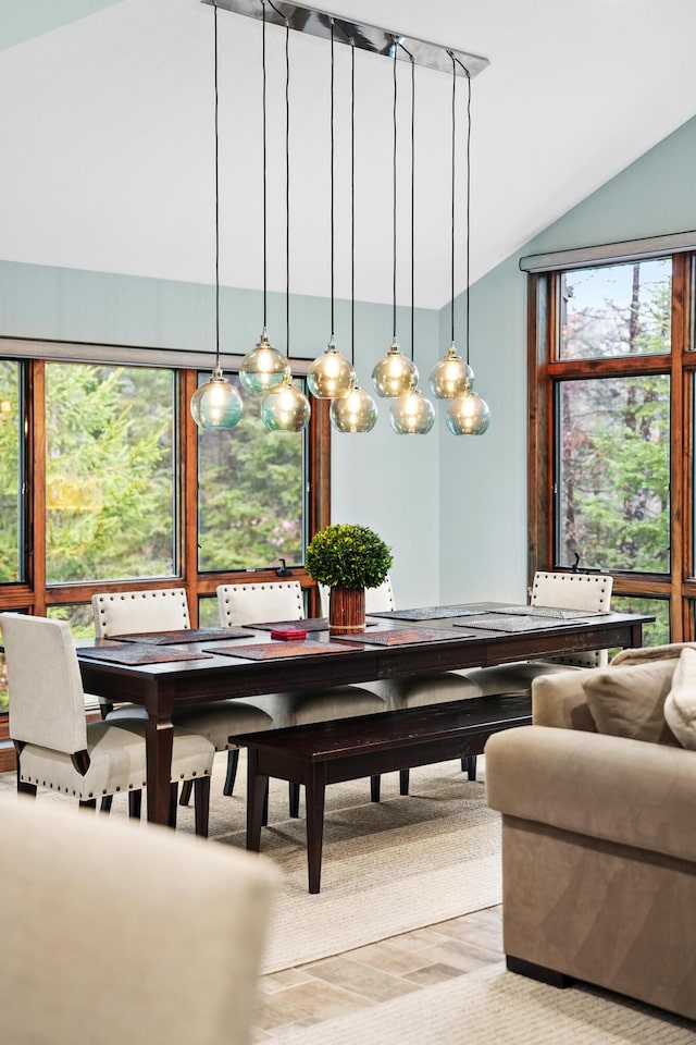 dining space with vaulted ceiling