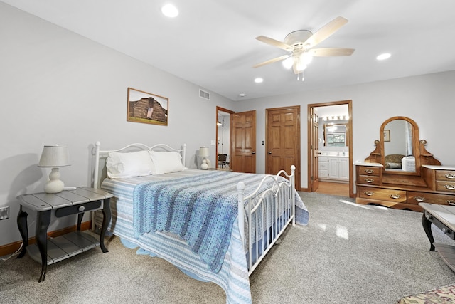 bedroom featuring recessed lighting, visible vents, light colored carpet, and ensuite bath