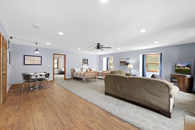 living area with a ceiling fan, recessed lighting, wood finished floors, and baseboards