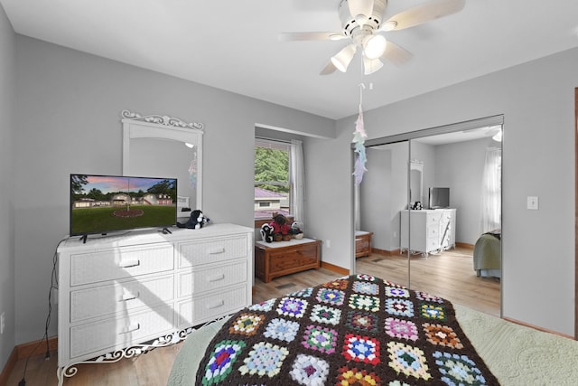 bedroom with a closet, a ceiling fan, baseboards, and wood finished floors