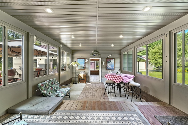 sunroom featuring wooden ceiling