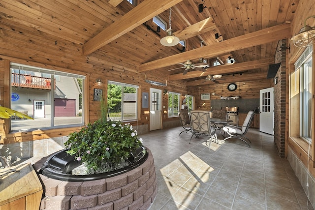 interior space with beam ceiling, wooden walls, and wood ceiling