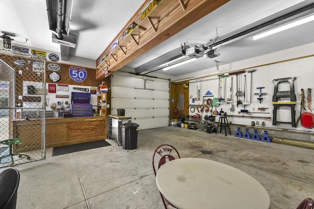 garage with a workshop area and a garage door opener