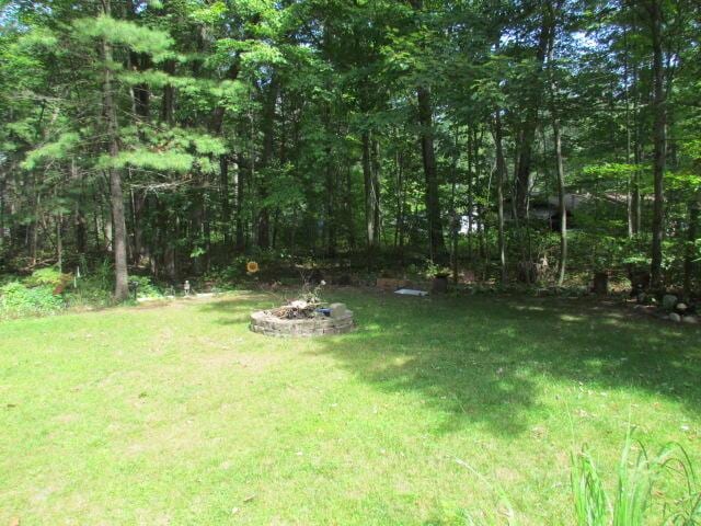 view of yard with an outdoor fire pit