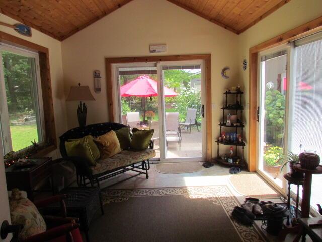 living area featuring lofted ceiling and wood ceiling