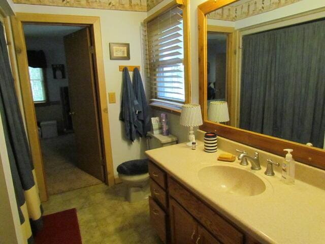 bathroom featuring toilet and vanity