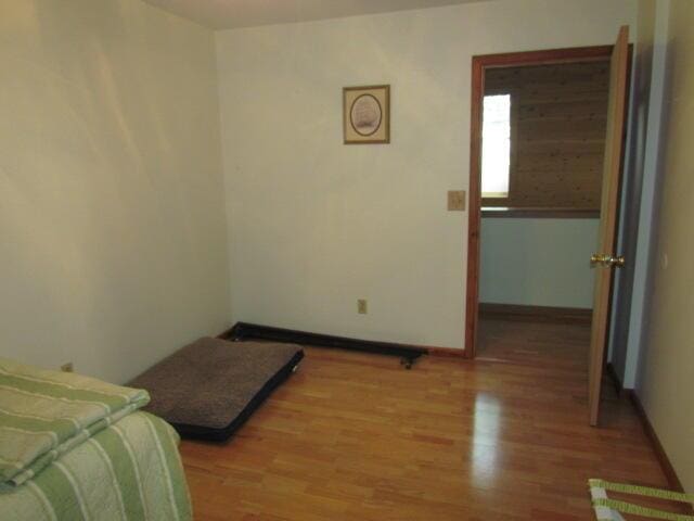 bedroom with light wood-style floors and baseboards