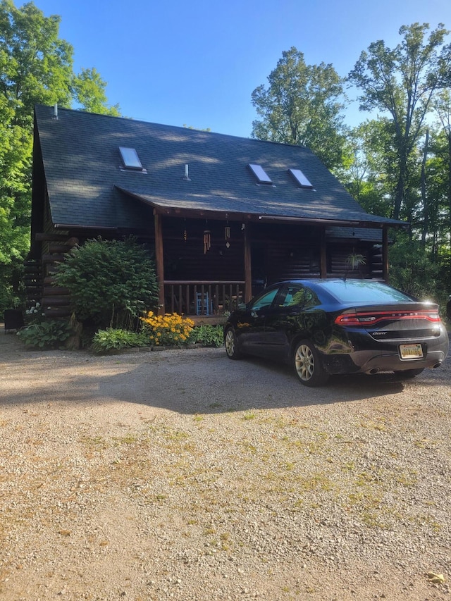 view of front of house with covered porch and a shingled roof