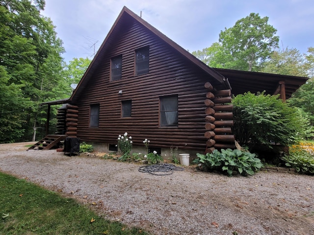 view of side of home with log exterior