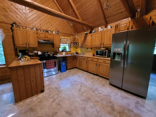 kitchen featuring under cabinet range hood, stainless steel appliances, wooden walls, and light countertops