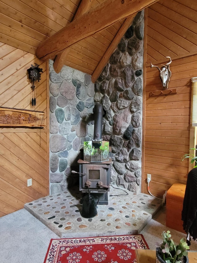 details featuring carpet floors, a wood stove, wood ceiling, wood walls, and beamed ceiling