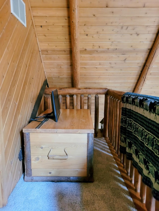 bedroom with visible vents, wood walls, and wooden ceiling