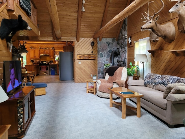 living room featuring light carpet, beam ceiling, and wood walls