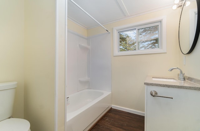 full bathroom with vanity, wood finished floors, baseboards, shower / tub combination, and toilet