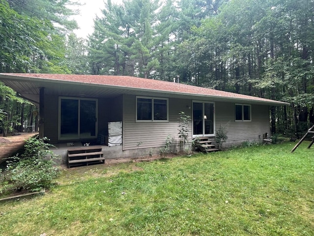 ranch-style home with entry steps and a front yard