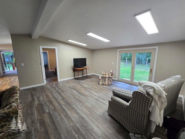 living room with vaulted ceiling with beams, baseboards, and wood finished floors