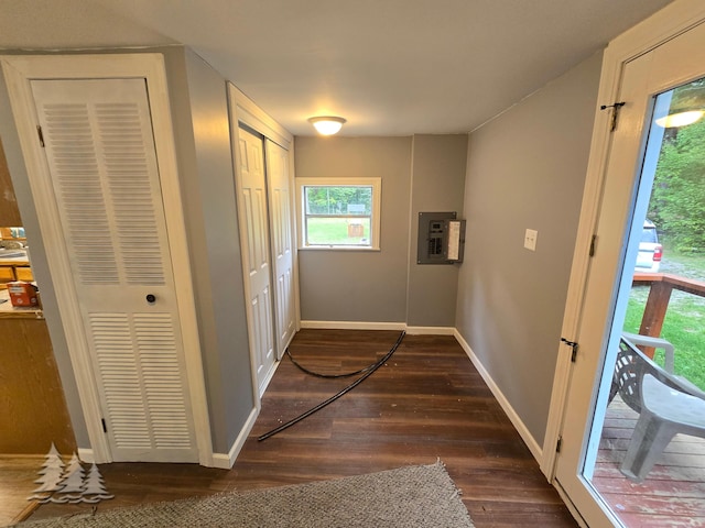 hallway with electric panel, baseboards, dark wood-style floors, and a heating unit