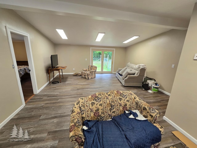 living area with baseboards and wood finished floors