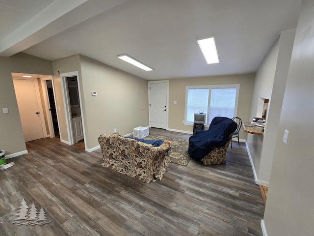 living area featuring baseboards and wood finished floors