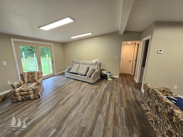 living area featuring lofted ceiling with beams, baseboards, and wood finished floors