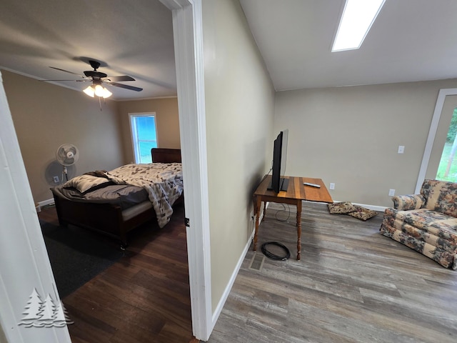 bedroom featuring baseboards, wood finished floors, and ornamental molding