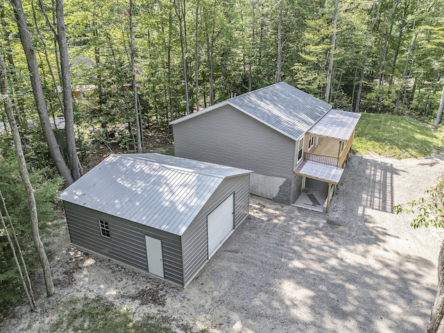 birds eye view of property featuring a view of trees