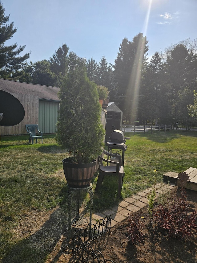 surrounding community featuring an outbuilding, a yard, and fence