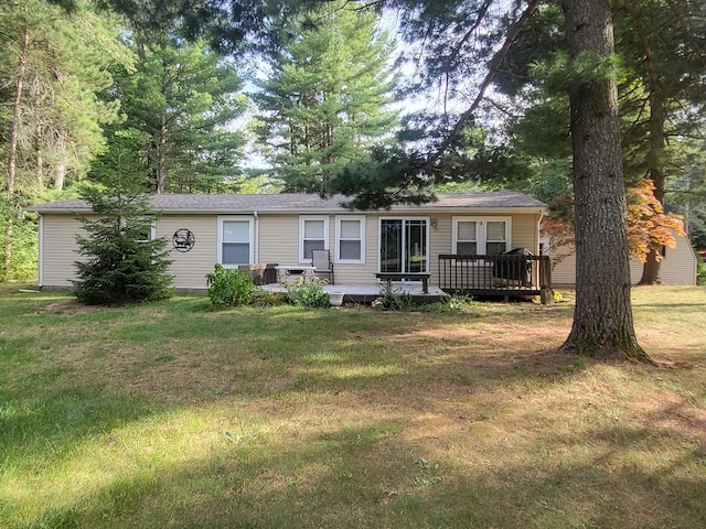 view of front of house featuring a front lawn and a wooden deck