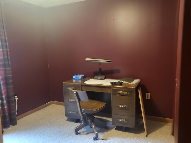 carpeted home office featuring baseboards