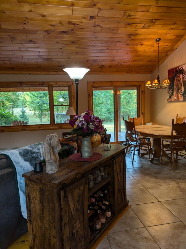 dining room featuring light tile patterned floors, a wealth of natural light, wooden ceiling, and vaulted ceiling