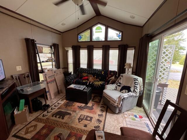 interior space with ceiling fan and vaulted ceiling