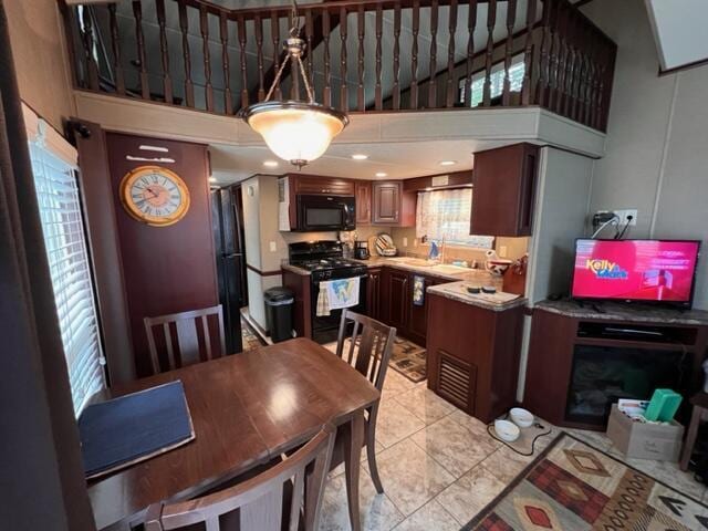 dining area featuring a high ceiling and light tile patterned floors