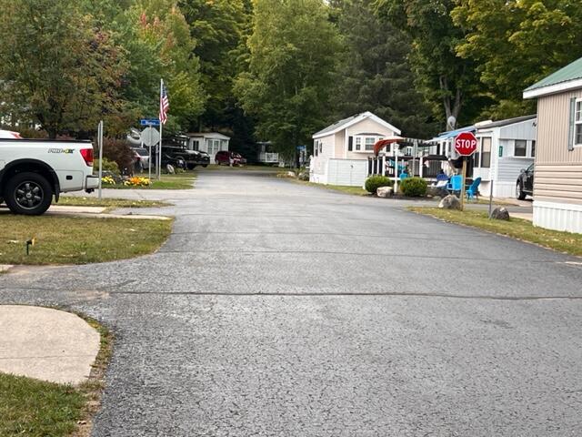 view of road featuring a residential view and traffic signs