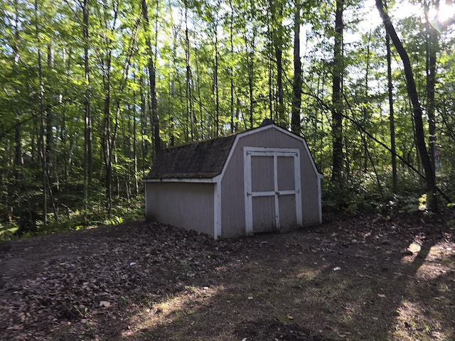 view of shed with a forest view