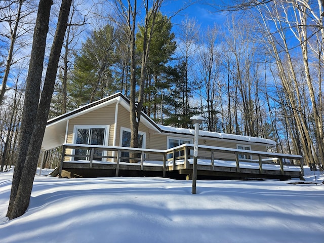 snow covered property featuring a wooden deck